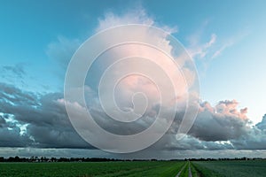 Thunderstorm with visible rain shaft is moving over the dutch countryside