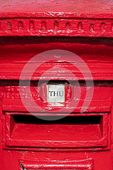 Thursday word shown as THU on a British red letter box.