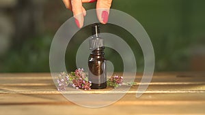 Thyme essential oil in  beautiful bottle on table