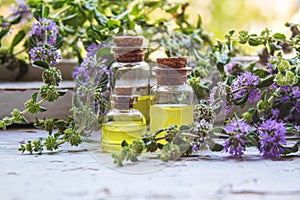 Thyme essential oil in a small bottle. selective focus