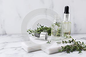 Thyme essential oil on white marble table, space for text