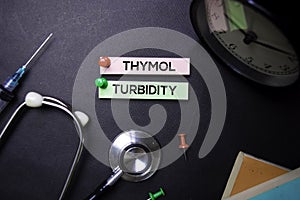Thymol Turbidity text on Sticky Notes. Top view isolated on black background. Healthcare/Medical concept photo