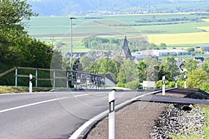 ThÃÂ¼r, Germany - 05 19 2021: The new road into ThÃÂ¼r with yellow fields in background