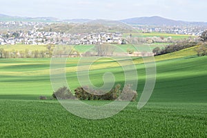 ThÃ¼r, Germany - 04 23 2021: Green wave shaped hills above village ThÃ¼r