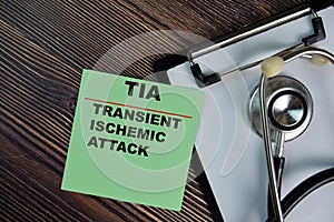 TIA - Transient Ischemic Attack write on sticky notes isolated on Wooden Table. medical concept