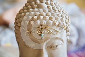 Tiara with gemstone on Buddha statue head