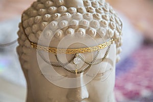 Tiara with gemstone on Buddha statue head