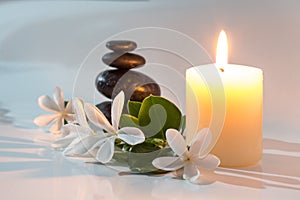 Tiare flowers, candle and black stone spa