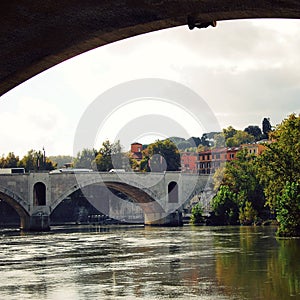 Tiber river and a PASA bridge in Rome. Aged photo.