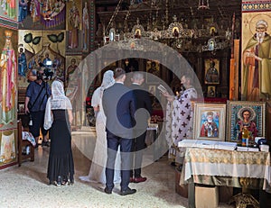 A priest reads a prayer at the wedding ceremony held in the Orthodox tradition in Greek Orthodox monastery of the twelve apostles