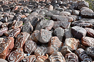 Tibet. Buddhist prayer stones with mantras and ritual drawings on the trail from the town of Dorchen around mount Kailash