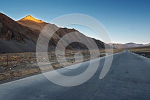 Tibet, snow-capped mountains under the dirt road, the car background