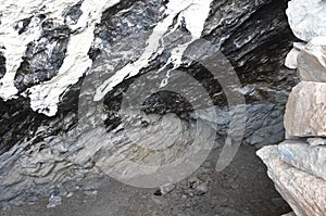 Tibet. Stoned entrance to small cave on the shore of Rakshas Tal lake