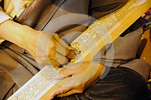 Tibetan artisan carving a sutra printing block