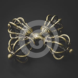 Tibetan bronze vadjra unique form on black background