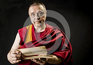 Tibetan Buddhist monk teacher in a burgundy yellow outfit suit with text mantra