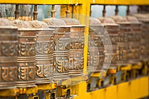 Tibetan Buddhist prayer wheels at Boudhanath stupa in Nepal.