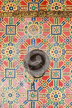 Tibetan doorknob on the colorful painted door