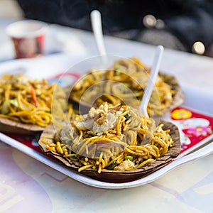 Tibetan fried noodle Thukpa served in dry leaves plate in village market in winter at Gangtok, Sikkim. India