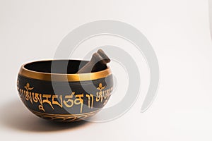 Tibetan handcrafted singing bowl with stick isolated on white background