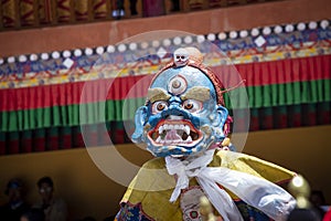 Tibetan man, dressed in a mystical mask, perform a dance during the Buddhist festival in Hemis monastery, Ladakh, India