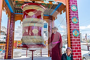 A Tibetan man playing the prayer wheel of Gompa Soma at the  Street of Leh City, Ladakh, Jammu and Kashmir