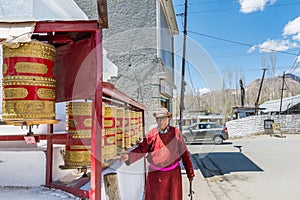 A Tibetan man playing the prayer wheel of Gompa Soma at the  Street of Leh City, Ladakh, Jammu and Kashmir