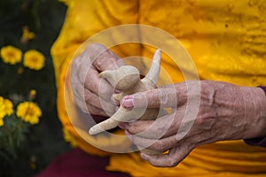 Tibetan monk sculpts figure of the deity barley flour tsampa in Nepal