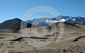 Tibetan mountain landscape, blue sky and sparse vegetation