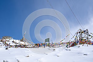 Tibetan prayer flag at Khardung La in winter. Khardung La is a mountain pass in the Ladakh region of the Indian state of Jammu and