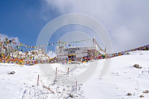 Tibetan prayer flag at Khardung La in winter. Khardung La is a mountain pass in the Ladakh region of the Indian state of Jammu and