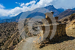 Tibetan prayer stupa or prayers place of the faithful Buddhists in center Mountains Path. Blue Sky Background