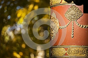 Tibetan Prayer Wheel and yellow Leafs