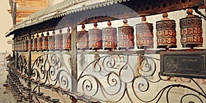 Tibetan Prayer Wheels with mantras near Swayambhunath Stupa - retro photo.