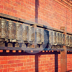 Tibetan Prayer Wheels with mantras near Swayambhunath Stupa - retro photo. photo