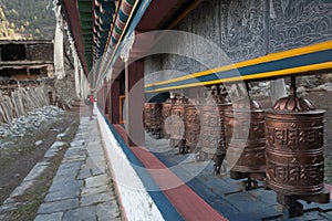 Tibetan prayer wheels or prayers rolls of the faithful Buddhists. Horizontal photo.
