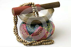 Tibetan Singing Bowl with sandalwood prayer beads photo