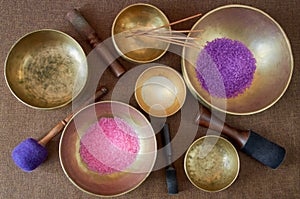 Tibetan singing bowls  with healing salt and  aroma sticks on the cloth background - music instruments for meditation, relaxation