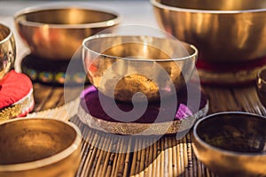 Tibetan singing bowls on a straw mat