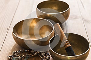 Tibetan singing bowls on a wooden table