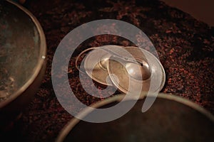 Tibetan tigsha cymbals with sound bowls. The concept of Tibetan rituals, meditations and sound therapy