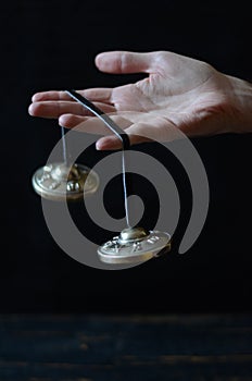 Tibetan tingsha (taal) cymbals on the hand - music instruments for meditation, relaxation, yoga