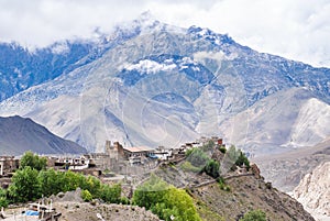 Tibetan village and Dhaulagiri mountain range on background.