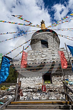 Tibetan white pagoda prayer flags at Siguniang Mountain in Chengdu, Sichuan, China.