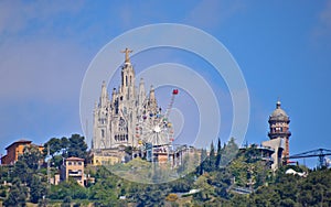 Tibidabo church on the mountain, with fun park around it photo