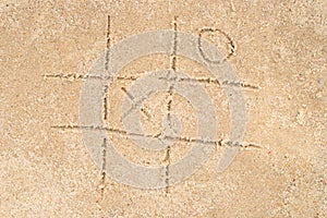 Tic-tac-toe drawing in sand