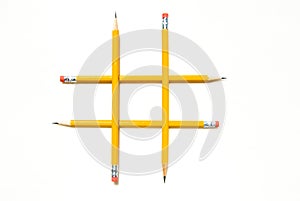 Tic-Tac-Toe Symbol with Yellow Pencils