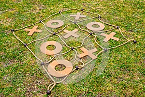Tic tac toe yard game placed on the grass.