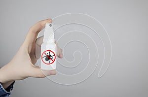 Tick repellant. Insect protection. Girl holds a spray on a white background that will protect against ticks. Repelling blood-