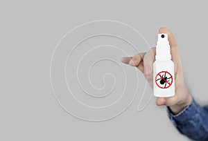 Tick repellant. Insect protection. Girl holds a spray on a white background that will protect against ticks. Repelling blood-